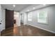 Inviting main bedroom with ensuite bathroom, large windows, and wood floors at 2137 Delowe Dr, Atlanta, GA 30344