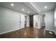 Bright main bedroom featuring hardwood floors, recessed lighting, and access to the bathroom and closet at 2137 Delowe Dr, Atlanta, GA 30344