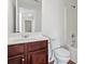 Bathroom featuring a cherry vanity and bath-shower combination at 221 Cutbank Sw Ct, Atlanta, GA 30331