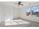 Bedroom featuring neutral walls and carpet, window bringing natural light, and a ceiling fan at 221 Cutbank Sw Ct, Atlanta, GA 30331