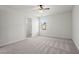 Bedroom with neutral carpet, ceiling fan and closet with shelving at 221 Cutbank Sw Ct, Atlanta, GA 30331