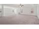 Expansive bonus room with plush carpet, neutral walls, and large windows offering plenty of natural light at 221 Cutbank Sw Ct, Atlanta, GA 30331