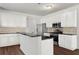 Well-lit kitchen featuring stainless steel appliances, granite countertops, white cabinets, and hardwood floors at 221 Cutbank Sw Ct, Atlanta, GA 30331