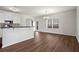 Bright, open kitchen with stainless steel appliances and dark countertops flowing into the dining area at 221 Cutbank Sw Ct, Atlanta, GA 30331