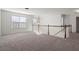 Open loft space features a wooden railing, lots of natural light, and plush carpeting at 221 Cutbank Sw Ct, Atlanta, GA 30331