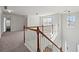 Spacious loft area with plush carpeting, neutral walls, and natural light from the large windows at 221 Cutbank Sw Ct, Atlanta, GA 30331