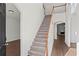 Welcoming foyer with a staircase featuring wood handrails and plush carpeting leading to the upper level at 221 Cutbank Sw Ct, Atlanta, GA 30331
