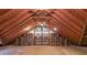 Unfinished attic offering exposed beams and built-in shelving for potential storage or customization at 3601 Club Nw Dr, Kennesaw, GA 30144
