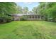 Expansive backyard featuring lush greenery, an enclosed porch and gazebo, creating a private outdoor oasis at 3601 Club Nw Dr, Kennesaw, GA 30144