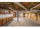 Basement with concrete flooring, exposed ceiling, with built-in wooden cabinets and shelves at 3601 Club Nw Dr, Kennesaw, GA 30144