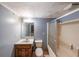 Basement bathroom featuring a single vanity, toilet, and shower/tub combo with glass door at 3601 Club Nw Dr, Kennesaw, GA 30144