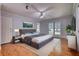 Primary bedroom with hardwood floors, ceiling fan, and natural light at 3601 Club Nw Dr, Kennesaw, GA 30144