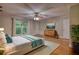 Bright bedroom with hardwood floors, ceiling fan, large window and area rug at 3601 Club Nw Dr, Kennesaw, GA 30144