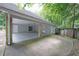 Large carport with a concrete floor and gray siding, offers convenient covered parking at 3601 Club Nw Dr, Kennesaw, GA 30144