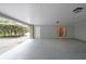 A spacious carport area with stone pillars, a concrete floor, and a view of the driveway at 3601 Club Nw Dr, Kennesaw, GA 30144