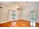 Cozy dining room featuring hardwood floors, modern lighting, bright, neutral walls and a view of the entry at 3601 Club Nw Dr, Kennesaw, GA 30144