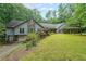 Beautifully landscaped home with an attached garage and well-maintained lawn and stone design features at 3601 Club Nw Dr, Kennesaw, GA 30144