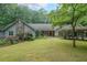 Charming single-story home with stone accents, mature landscaping, and a spacious front yard at 3601 Club Nw Dr, Kennesaw, GA 30144