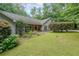 Well-manicured front lawn, complemented by mature trees and established shrubs, creating a welcoming facade at 3601 Club Nw Dr, Kennesaw, GA 30144