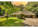 Charming single-story home with a covered entrance, lush lawn, and mature trees in a serene setting at 3601 Club Nw Dr, Kennesaw, GA 30144