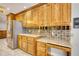 Functional kitchen with stainless-steel refrigerator, wood cabinetry, and granite countertops at 3601 Club Nw Dr, Kennesaw, GA 30144