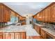 Spacious kitchen featuring wooden cabinetry, granite countertops, stainless steel appliances, and tile flooring at 3601 Club Nw Dr, Kennesaw, GA 30144