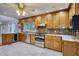 Bright kitchen featuring ample wood cabinetry, stainless steel appliances, and a stylish tile floor at 3601 Club Nw Dr, Kennesaw, GA 30144