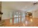 Open living room featuring hardwood floors, a stone fireplace, with views of the dining and kitchen area at 3601 Club Nw Dr, Kennesaw, GA 30144