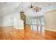 Bright living room featuring hardwood floors, a stone fireplace, vaulted ceilings, and large windows at 3601 Club Nw Dr, Kennesaw, GA 30144