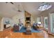 Bright living room featuring hardwood floors, stone fireplace, vaulted ceilings, and modern furnishings at 3601 Club Nw Dr, Kennesaw, GA 30144