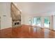 Open living room with stone fireplace, hardwood floors, and glass doors to a deck at 3601 Club Nw Dr, Kennesaw, GA 30144