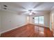 Sunlit living room with hardwood floors and a ceiling fan, creating a warm and inviting atmosphere at 3601 Club Nw Dr, Kennesaw, GA 30144