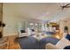 Open living room featuring hardwood floors, a stone fireplace, with views of the dining and kitchen area at 3601 Club Nw Dr, Kennesaw, GA 30144
