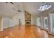 Bright living room featuring hardwood floors, a stone fireplace, vaulted ceilings, and large windows at 3601 Club Nw Dr, Kennesaw, GA 30144