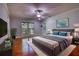 Tranquil main bedroom with large windows, wooden floor, soft colors, and plush bedding at 3601 Club Nw Dr, Kennesaw, GA 30144