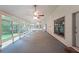 Spacious sunroom with windows and a ceiling fan, perfect for enjoying the outdoors indoors at 3601 Club Nw Dr, Kennesaw, GA 30144