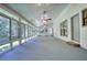 Bright sunroom with multiple windows offering natural light and views of the surrounding landscape at 3601 Club Nw Dr, Kennesaw, GA 30144