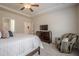 Relaxing bedroom featuring a tray ceiling with fan, wood dresser, and comfortable seating area at 422 Murphy Avenue, Canton, GA 30114