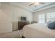 Well-lit bedroom with a tray ceiling and fan, complemented by a wood dresser and large windows at 422 Murphy Avenue, Canton, GA 30114