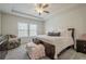 Bright bedroom featuring plush carpeting, a tray ceiling with fan, and large windows for ample natural light at 422 Murphy Avenue, Canton, GA 30114