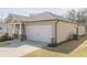 Showing the right side of the home with a two-car garage, nice landscaping, and neutral colored siding at 422 Murphy Avenue, Canton, GA 30114