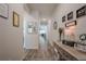 Hallway with beautiful luxury vinyl plank floors with decorations along the wall leading to the living room at 422 Murphy Avenue, Canton, GA 30114