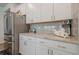 Modern kitchen featuring stainless steel refrigerator and white cabinets with stylish hardware and granite countertops at 422 Murphy Avenue, Canton, GA 30114