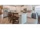 Modern kitchen with white cabinets, stainless appliances, and a spacious island with breakfast bar seating at 422 Murphy Avenue, Canton, GA 30114