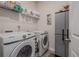 Well-organized laundry room with modern washer, dryer, storage cabinet, and shelving at 422 Murphy Avenue, Canton, GA 30114