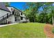A view of the backyard featuring a well-maintained lawn, a deck and stairs at 1155 Peachtree Battle Nw Ave, Atlanta, GA 30327