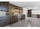 Finished basement with dark cabinetry, wine cooler, wet bar, and shelving, perfect for entertaining at 1155 Peachtree Battle Nw Ave, Atlanta, GA 30327