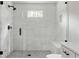 Modern bathroom features a glass-enclosed shower with white tiled walls and black hardware at 1155 Peachtree Battle Nw Ave, Atlanta, GA 30327