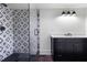 Contemporary bathroom with black vanity, and a glass shower stall with geometric pattern at 1155 Peachtree Battle Nw Ave, Atlanta, GA 30327