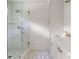 Bathroom featuring a glass shower, white cabinets and countertops, and marble-patterned flooring at 1155 Peachtree Battle Nw Ave, Atlanta, GA 30327